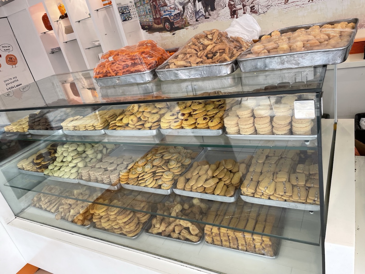 Trays of freshly baked Pakistani biscuits and cookies in the bakery display at Original Gourmet
