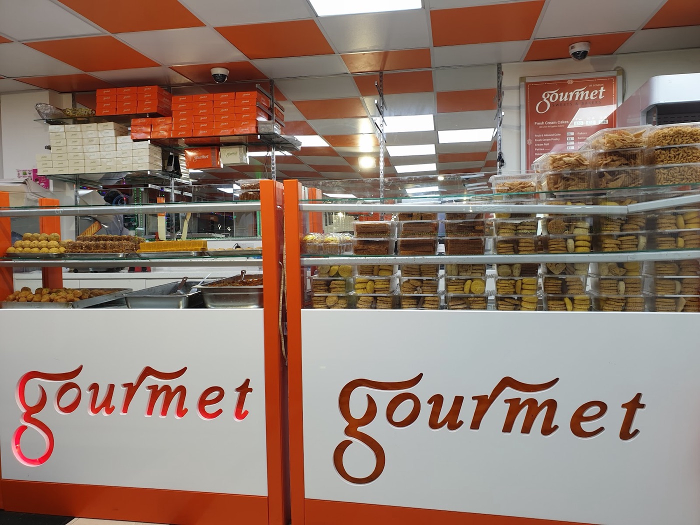 The branded Gourmet counter with stacked gift boxes and the script Gourmet wordmark